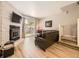 Cozy living room features a stone fireplace, modern flooring, and backyard access at 9736 W Cornell Pl, Lakewood, CO 80227