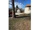 View of the concrete driveway and damaged back of the property at 1165 S Winona Ct, Denver, CO 80219