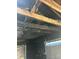 Heavily burned ceiling shows charred wooden beams and extensive structural damage at 1165 S Winona Ct, Denver, CO 80219