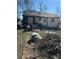Front exterior showing damage and boarded-up windows at 1165 S Winona Ct, Denver, CO 80219