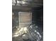Burned room with debris, and boarded up window, revealing damage from a fire at 1165 S Winona Ct, Denver, CO 80219