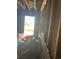 Damaged interior with debris, exposed walls and studs visible near an open doorway at 1165 S Winona Ct, Denver, CO 80219