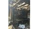 Damaged interior showing burned walls, exposed beams, and signs of significant fire damage at 1165 S Winona Ct, Denver, CO 80219
