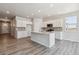 Bright kitchen features white cabinets, a center island, and stainless steel appliances at 25023 N 34Th Ave, Aurora, CO 80019