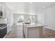 Spacious kitchen boasts white cabinets, stainless appliances, and a large center island at 25023 N 34Th Ave, Aurora, CO 80019