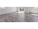 Open-concept living room features gray wood floors and lots of natural light at 25023 N 34Th Ave, Aurora, CO 80019