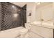 Stylish bathroom with sleek tub, black and white patterned tile, and gold fixtures at 2540 Kendall St, Edgewater, CO 80214