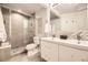 This bathroom has an enclosed shower and a double sink vanity with modern fixtures at 2540 Kendall St, Edgewater, CO 80214