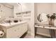 Bright bathroom featuring double sinks, ample counter space, and modern fixtures at 2540 Kendall St, Edgewater, CO 80214