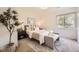 Cozy bedroom with a soft rug, comfy bench, neutral tones, and ample natural light at 2540 Kendall St, Edgewater, CO 80214