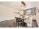 Elegant dining room featuring wood floors, modern lighting, and a patterned accent wall at 2540 Kendall St, Edgewater, CO 80214