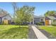 Attractive home exterior boasting a lush green lawn and a inviting walkway at 2540 Kendall St, Edgewater, CO 80214