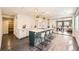 Open kitchen with white cabinets, quartz countertop island, and modern lighting at 2540 Kendall St, Edgewater, CO 80214