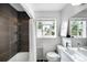 Cozy bathroom featuring a shower/tub combo, large window, and modern fixtures that maximize space and style at 2383 Jasmine St, Denver, CO 80207
