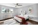 Bright bedroom with an area rug, radiator, and multiple windows providing natural light at 2383 Jasmine St, Denver, CO 80207