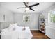 Bright bedroom featuring natural light, hardwood floors, and shelving, creating a comfortable and inviting space at 2383 Jasmine St, Denver, CO 80207