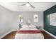 A well-lit bedroom features hardwood floors and a ceiling fan with a contemporary styled design at 2383 Jasmine St, Denver, CO 80207