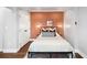 Stylish bedroom with modern lighting, a decorative accent wall, and a comfortable bed with decorative pillows at 2383 Jasmine St, Denver, CO 80207