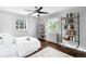 Bright bedroom featuring natural light, hardwood floors, and shelving, creating a comfortable and inviting space at 2383 Jasmine St, Denver, CO 80207