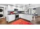 Open-concept kitchen with a gas range, stainless steel appliances, and seamless access to the dining area at 2383 Jasmine St, Denver, CO 80207