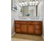 Bathroom vanity with double sinks, granite countertop, decorative art, and contemporary lighting fixtures at 3482 E 28Th Ave, Denver, CO 80205