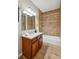 Bathroom with wood vanity, granite countertop, and tiled shower-tub combination at 3482 E 28Th Ave, Denver, CO 80205