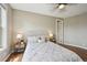 Bright bedroom featuring a ceiling fan, bedside lamps and neutral walls and wood flooring at 3482 E 28Th Ave, Denver, CO 80205