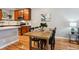 Dining area with seating for four features wood flooring, bright natural light and adjacent kitchen at 3482 E 28Th Ave, Denver, CO 80205