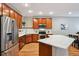 Modern kitchen with stainless steel appliances, quartz countertops, and wooden cabinetry at 3482 E 28Th Ave, Denver, CO 80205