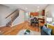 Open-concept living room features hardwood floors, recessed lighting, and an adjacent modern kitchen and staircase at 3482 E 28Th Ave, Denver, CO 80205