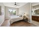 A cozy bedroom featuring a large window, neutral colors, and an ensuite bathroom at 3482 E 28Th Ave, Denver, CO 80205