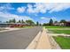 Charming street view featuring well-maintained homes, mature trees, and manicured lawns under a blue sky at 3482 E 28Th Ave, Denver, CO 80205