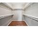 Walk-in closet with wood floor, white shelves, and hanging racks for optimal storage at 3482 E 28Th Ave, Denver, CO 80205