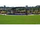 Community amphitheater with seating, shade structure, and lush landscaping at 8406 Pebble Creek Way # 202, Highlands Ranch, CO 80126