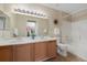 Bathroom featuring dual sinks, a well-lit mirror, and a shower-tub combo for relaxing and refreshed bathing at 8406 Pebble Creek Way # 202, Highlands Ranch, CO 80126