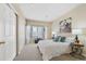 Bright bedroom with white bedding and large sliding door closet at 8406 Pebble Creek Way # 202, Highlands Ranch, CO 80126