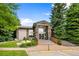 Clubhouse featuring stone accents, green lawn, and a convenient disability access ramp at 8406 Pebble Creek Way # 202, Highlands Ranch, CO 80126