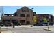 Commercial building with a bistro and pub with outside seating, offering dining and entertainment options at 8406 Pebble Creek Way # 202, Highlands Ranch, CO 80126