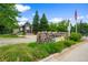 Canyon Ranch stone sign with beautiful flower beds and view of the clubhouse in background at 8406 Pebble Creek Way # 202, Highlands Ranch, CO 80126