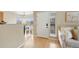 Bright entryway with wood floors, a view of the dining area, and a cozy seating area at 8406 Pebble Creek Way # 202, Highlands Ranch, CO 80126