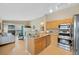 A modern kitchen featuring stainless steel appliances and access to a living room and balcony at 8406 Pebble Creek Way # 202, Highlands Ranch, CO 80126