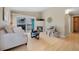 Bright living room with balcony access, features a fireplace and floods the space with natural light and a modern design at 8406 Pebble Creek Way # 202, Highlands Ranch, CO 80126