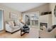 Cozy living room with fireplace and access to the balcony, creating a seamless indoor-outdoor living experience at 8406 Pebble Creek Way # 202, Highlands Ranch, CO 80126