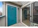 Covered patio with turquoise door at 8406 Pebble Creek Way # 202, Highlands Ranch, CO 80126