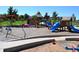 Community playground with swings, slides, and climbing structures, providing a fun and safe play area at 8406 Pebble Creek Way # 202, Highlands Ranch, CO 80126