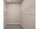 Bright walk-in closet featuring neutral walls, carpet and shelving for optimal storage at 8406 Pebble Creek Way # 202, Highlands Ranch, CO 80126
