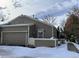 Exterior view of a cozy home, complete with a fenced yard, and attached garage at 5898 W Asbury Pl, Lakewood, CO 80227