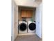 Convenient laundry closet with side-by-side washer and dryer and storage space at 5898 W Asbury Pl, Lakewood, CO 80227