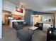Open-concept living room with vaulted ceilings, stylish gray furniture, and adjoining kitchen at 5898 W Asbury Pl, Lakewood, CO 80227