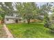 Lush backyard with mature trees and well-maintained lawn providing a serene outdoor space at 2565 S Gaylord St, Denver, CO 80210